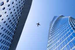 image of a plane flying between two buildings to illustrate a post about airframe design